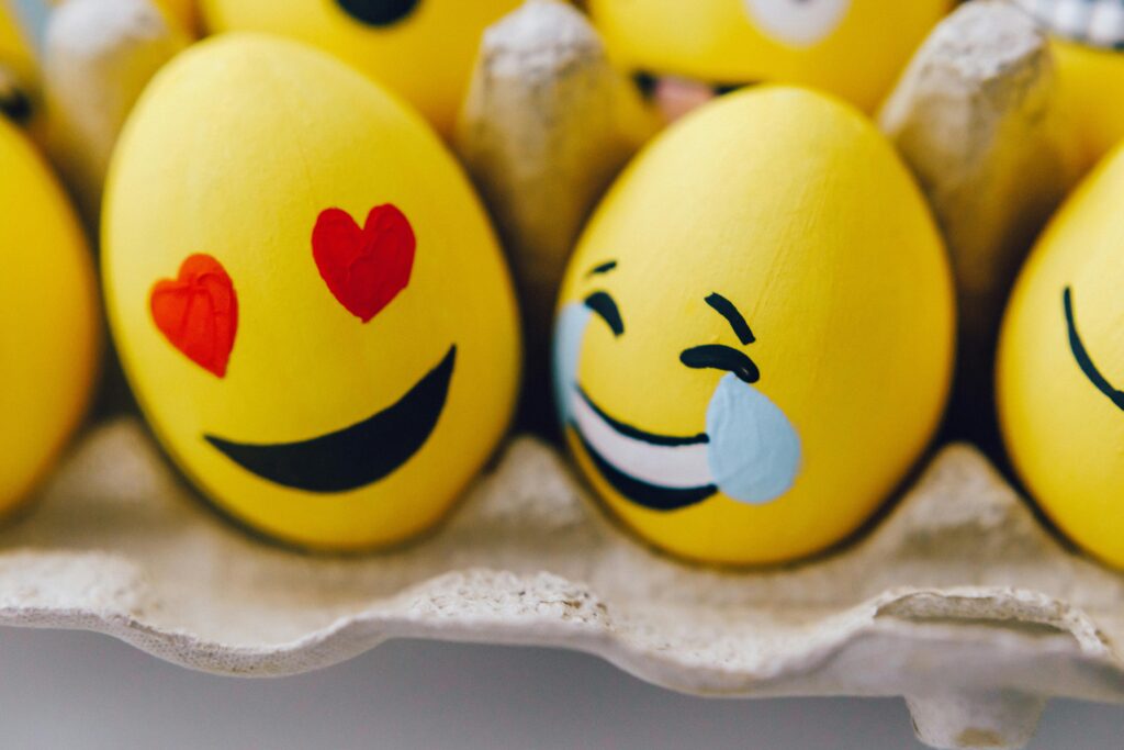 painted yellow eggs with drawn facial expressions